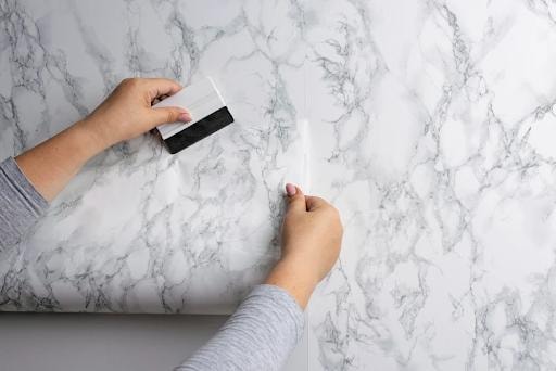 Close-up of marble wallpaper being installed and smoothed — Agoura Hills CA