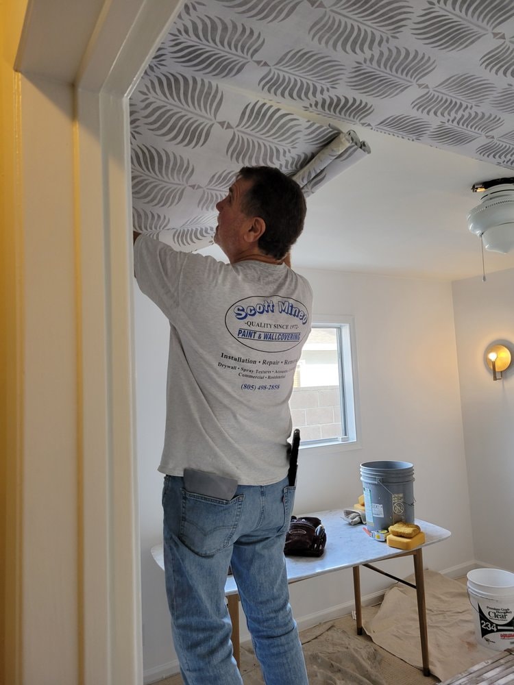 Scott Mineo installing wallcovering