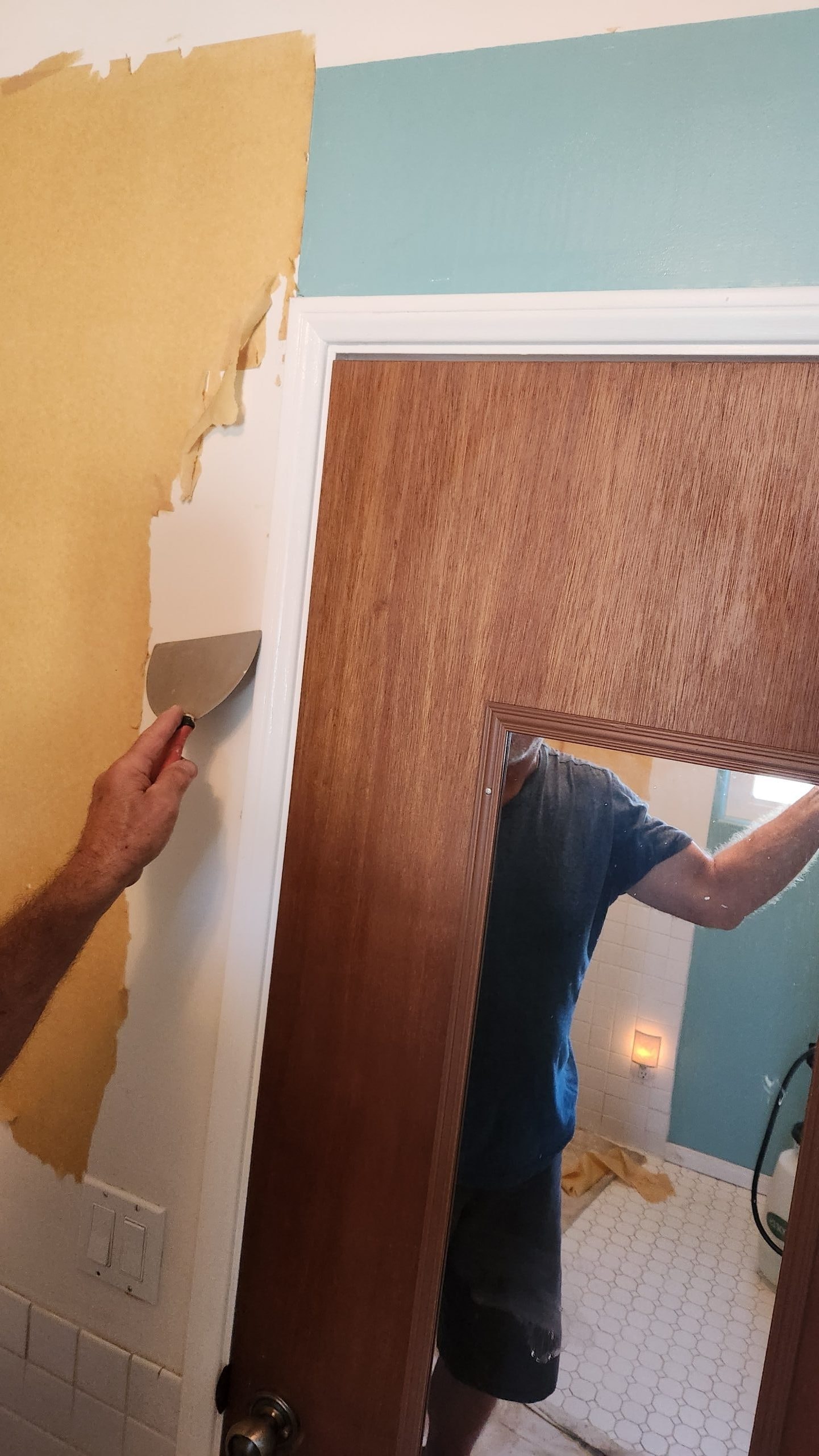 Wallpaper removal — scraping wall surface clean